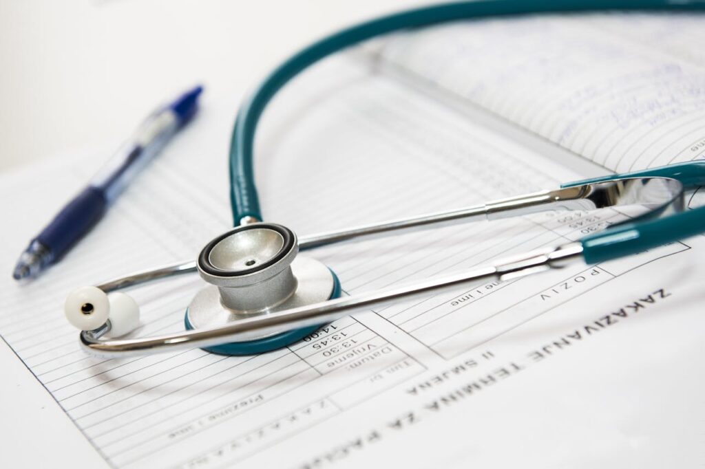 medical-appointment-doctor-healthcare-40568 A stethoscope and pen resting on a medical report in a healthcare setting.
